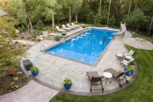 backyard concrete pool deck with chairs in mooresville, nc